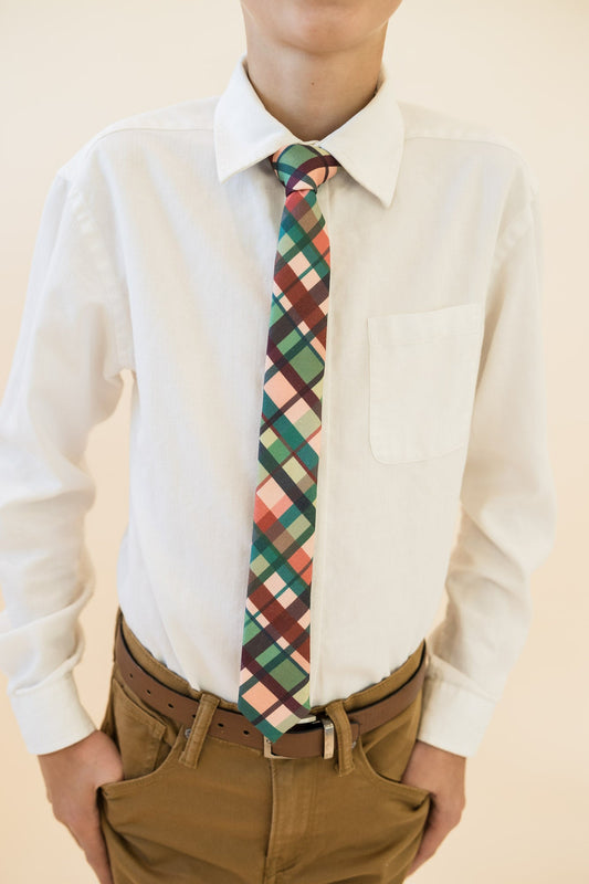 Youth plaid necktie worn with white button-up shirt; teal, green, tan, and rust plaid
