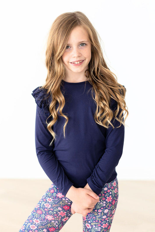 Navy long-sleeve ruffle shoulder tee on model, crew neck