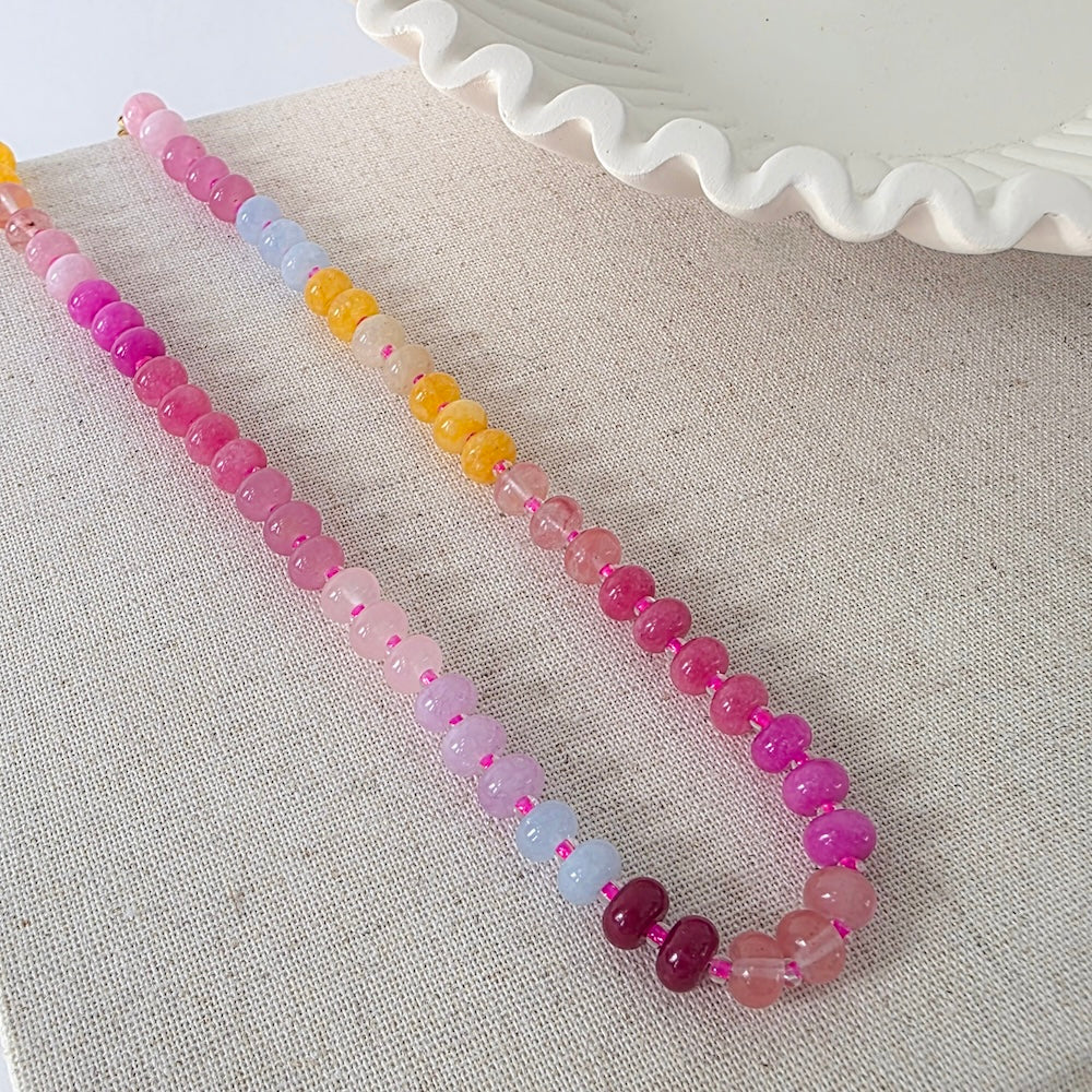 Waterproof ombre beaded necklace with pink, purple, and clear beads plus orange accent beads