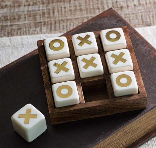 Tic tac toe game set with wooden box and white dice tiles marked X and O
