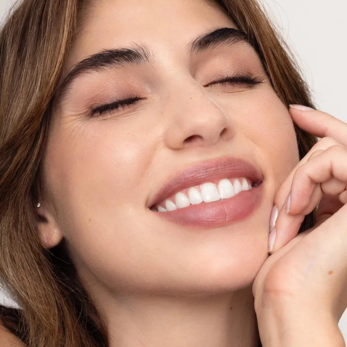 Mauve-pink lip tint on smiling lips