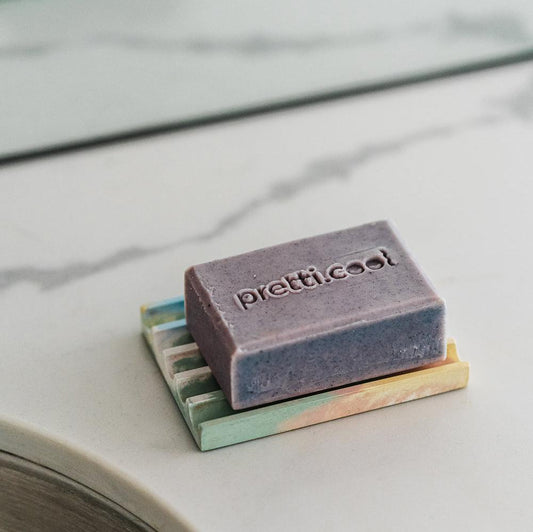 Rectangular soap tray holding a lavender soap bar