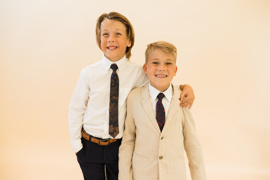 Boys patterned neckties in navy and merlot, worn with dress shirts