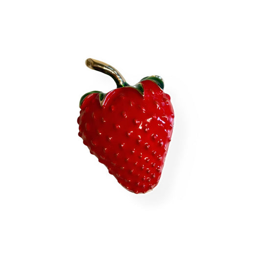 Red strawberry enamel brooch with green leaves and gold pin, isolated