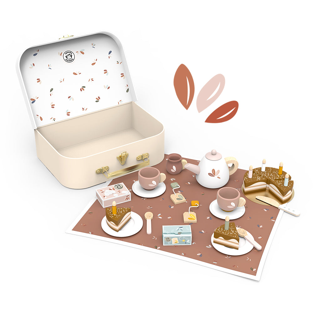 Tea set playset in open box with teapot, cups, cake slices, and candle accessories