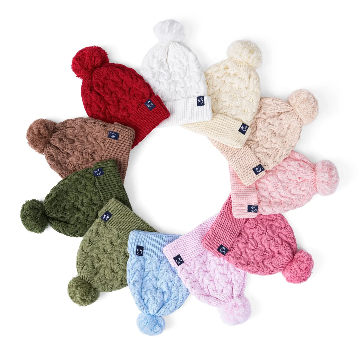 Kids pom beanie assortment arranged in a circle, assorted colors