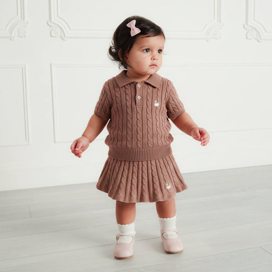 Toddler wearing mocha cable-knit polo sweater with short sleeves, ribbed collar, button placket.