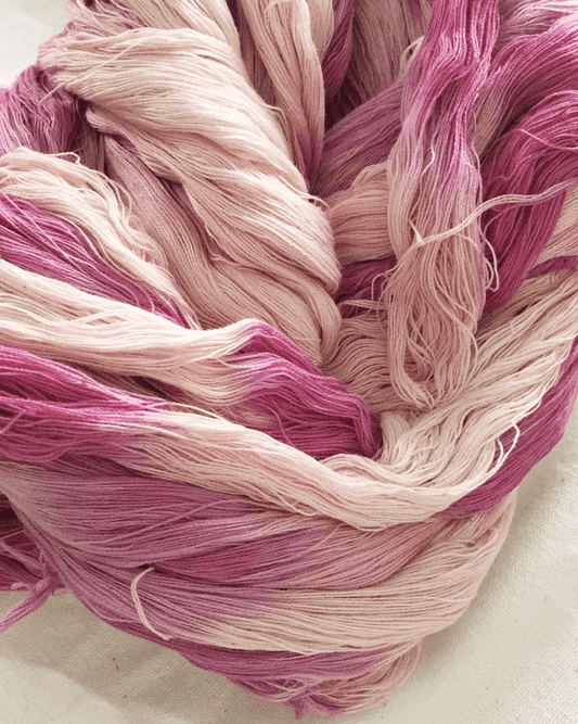 Pink natural-dyed shibori tassels detail with layered threads in light and dark shades.