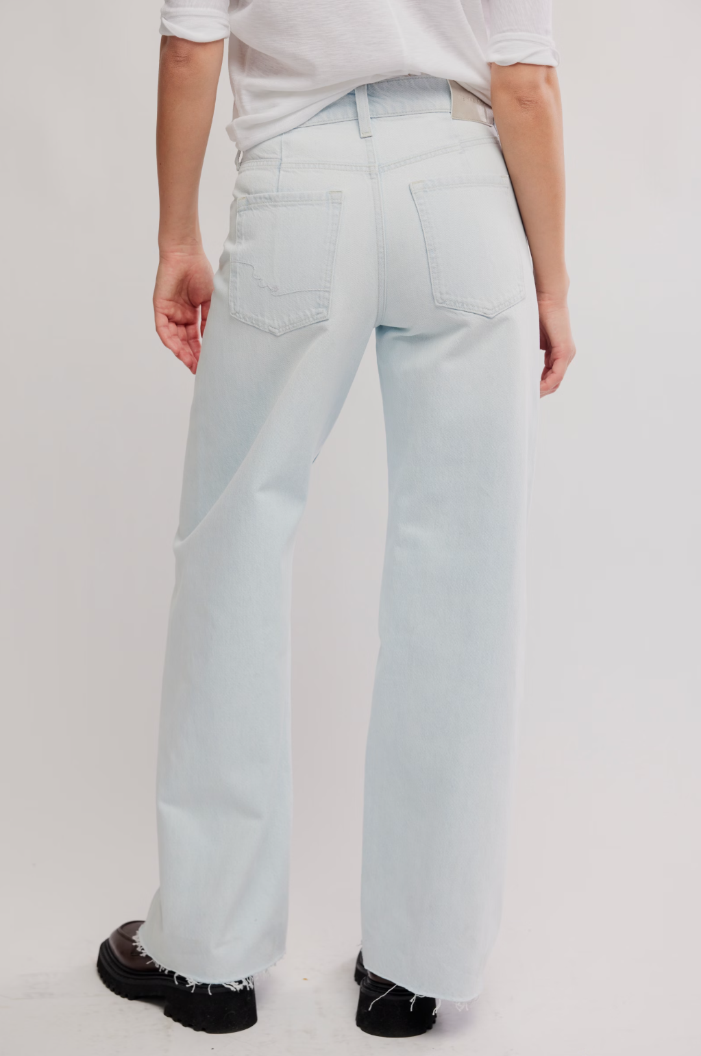 Light blue wide-leg jeans, back view with patch pockets and straight waistband
