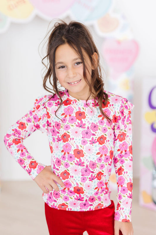 Girls' long-sleeve ruffle tee with bright pink/red floral print and gathered sleeves
