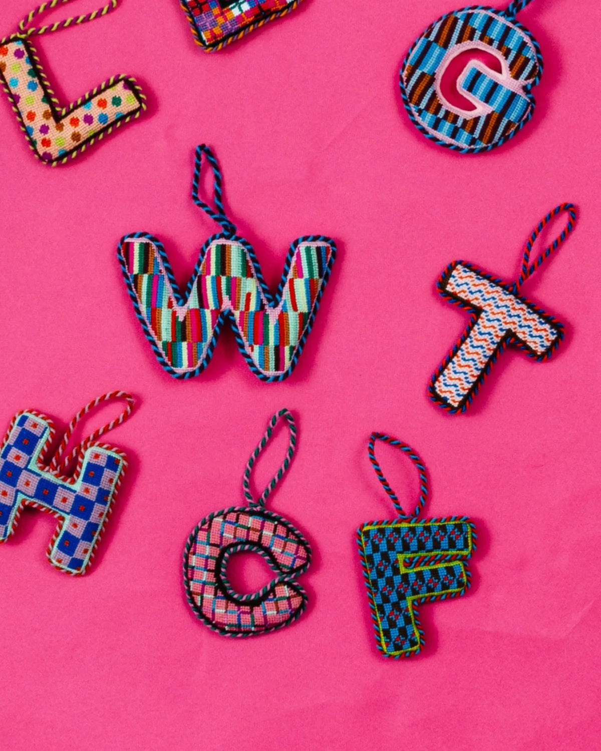 Needlepoint monogram ornament letter C, pink-and-teal stitched hoop with hanging loop.