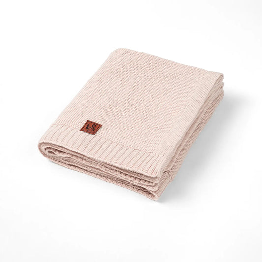 Beige knit cotton baby blanket with ribbed border and small fabric logo patch