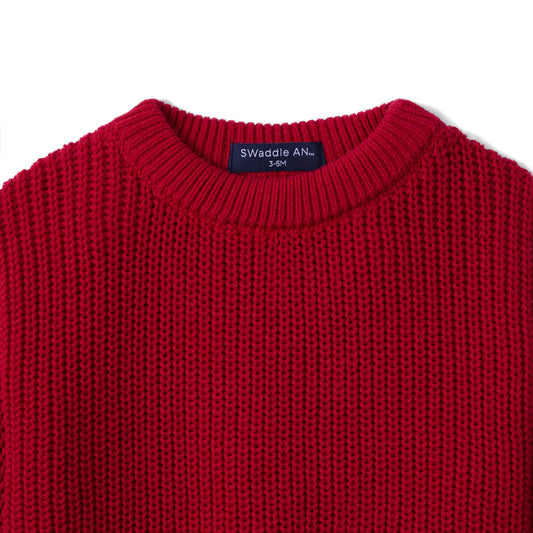 Red knit baby romper neckline with ribbed collar and size label