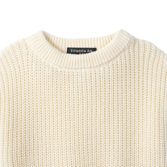Cream chunky knit baby romper neckline and brand label detail