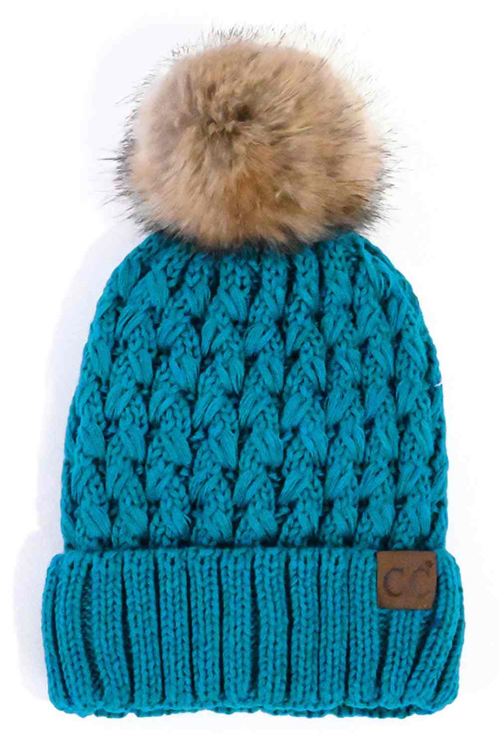 Teal knit beanie with brown pom-pom and ribbed cuff, C.C. leather patch