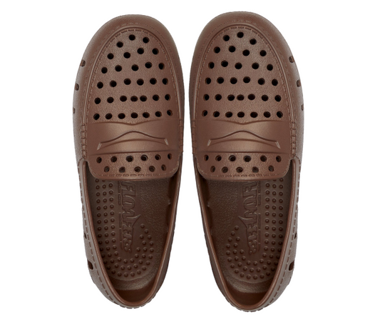 Kids brown loafer bottoms with circular grip dots and embossed logo detail