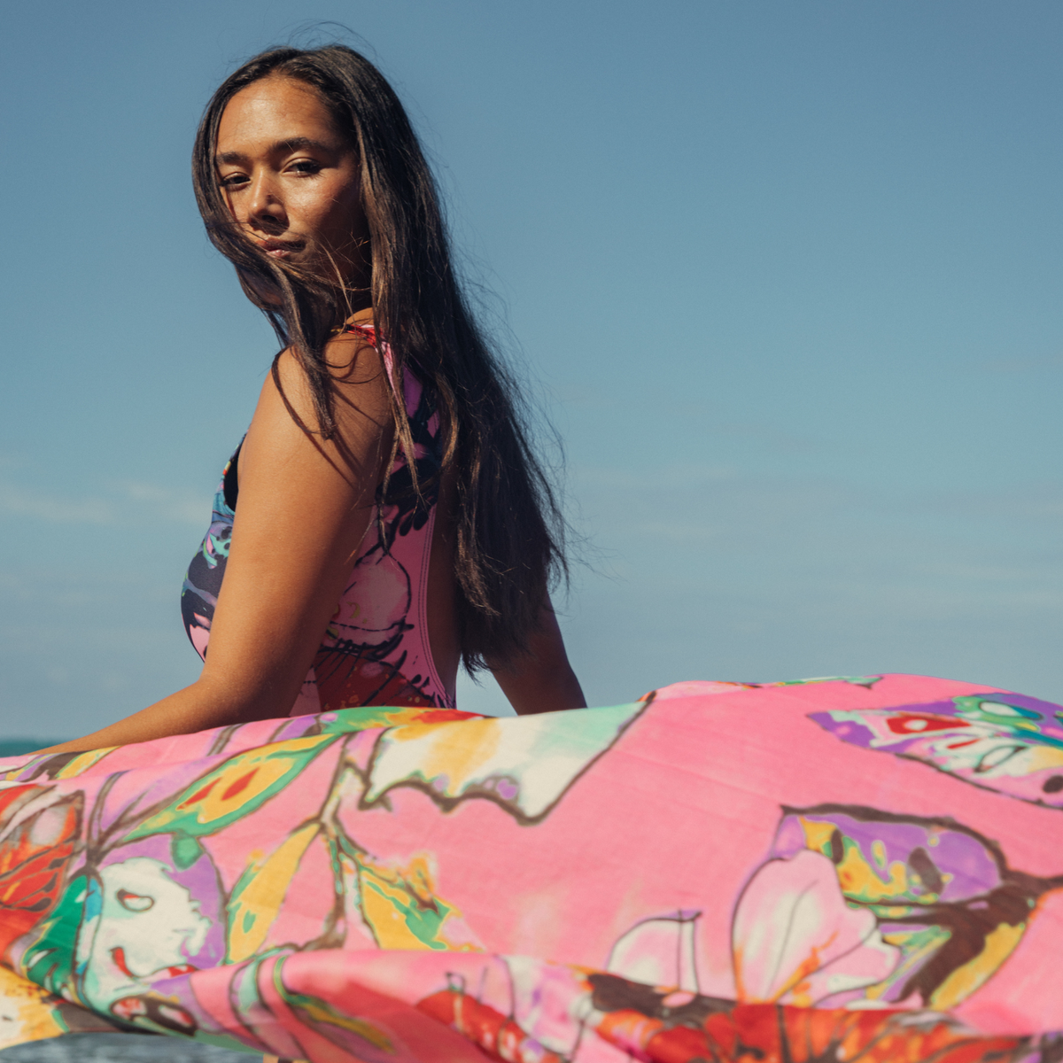Women's one-piece swimsuit with colorful abstract floral print, front close-up