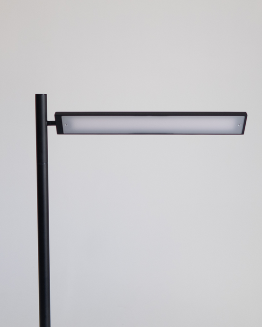 Black floor lamp head with horizontal LED light bar and vertical support pole