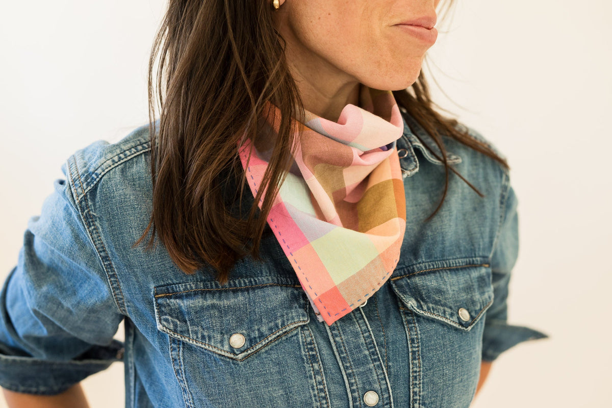 Side view of womens plaid bandana tied under chin
