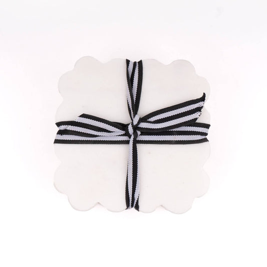 Scalloped white coaster with black-and-white striped ribbon bow