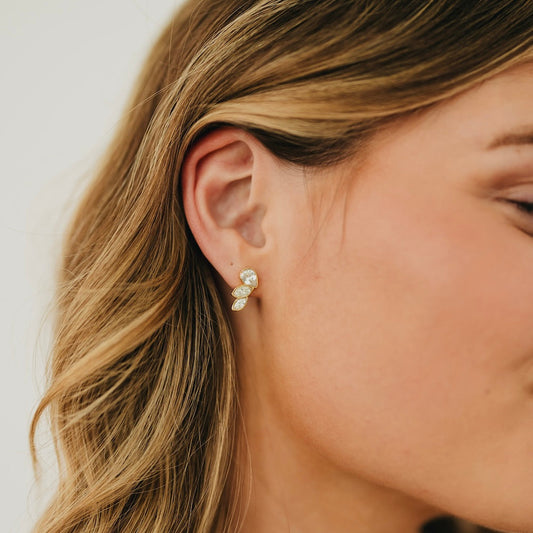 Gold-tone angel wing stud earrings, side view, crystal-like stones