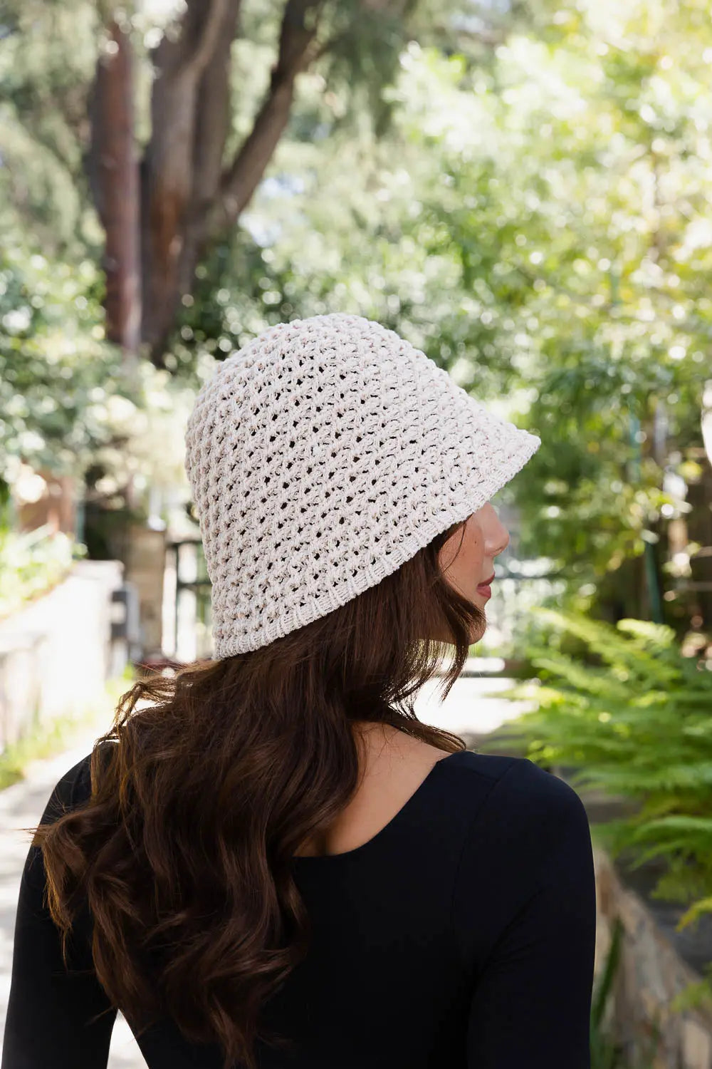 Natural handwoven crochet bucket hat side profile with wide brim and crochet texture
