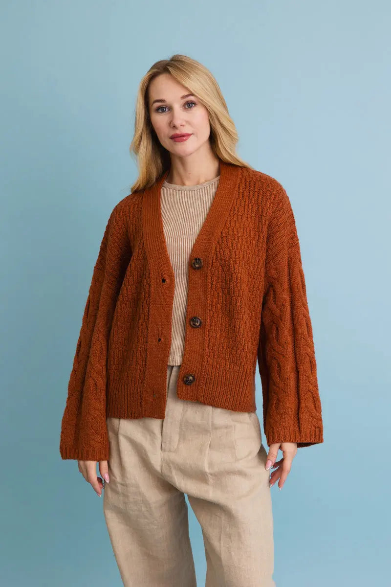 Brown/orange button-front textured cardigan with long sleeves; front view.