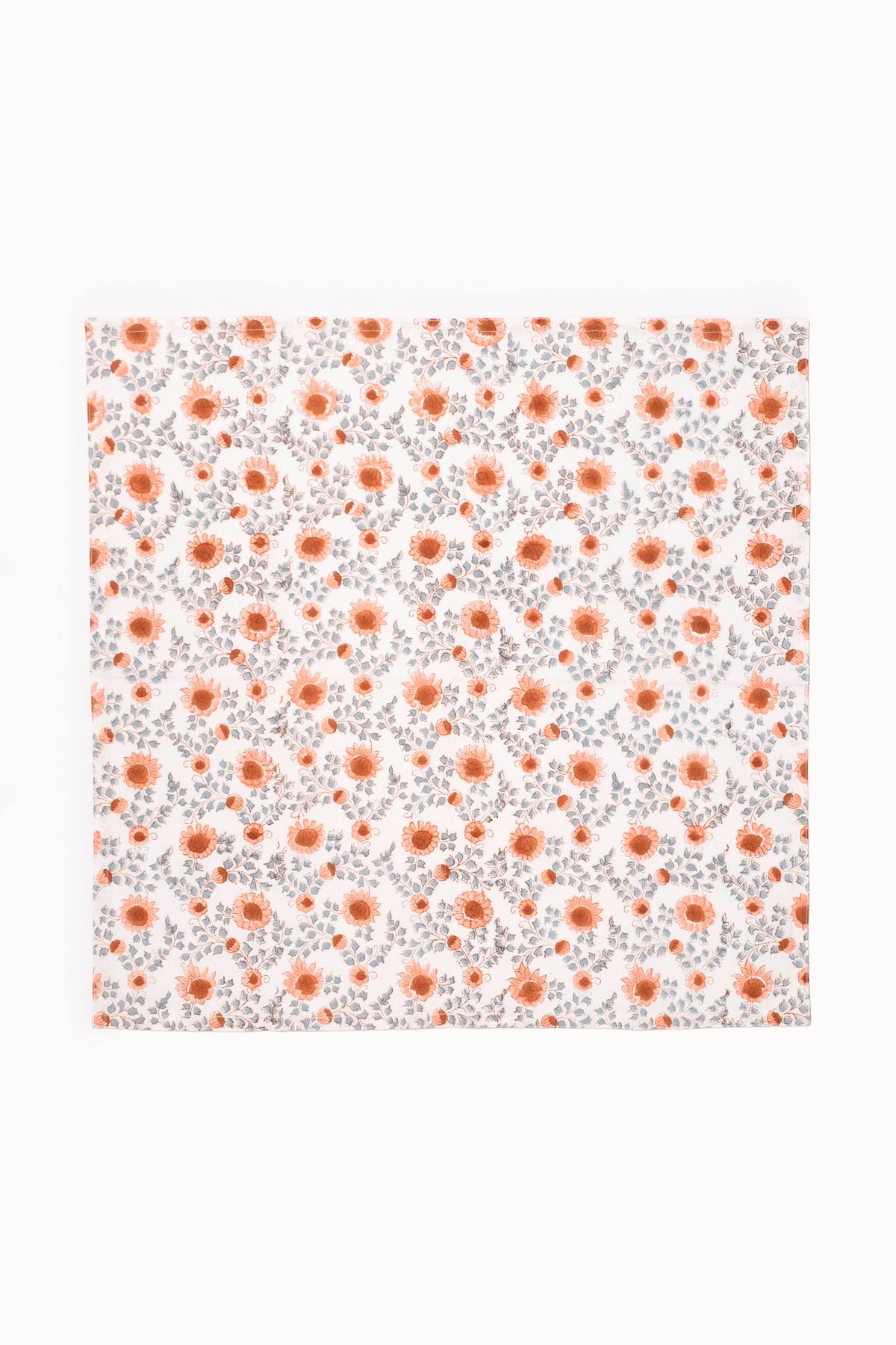 Floral block-printed napkin; terracotta blooms on white fabric, flat view