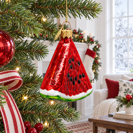 Hanging watermelon slice glass Christmas ornament on a tree branch