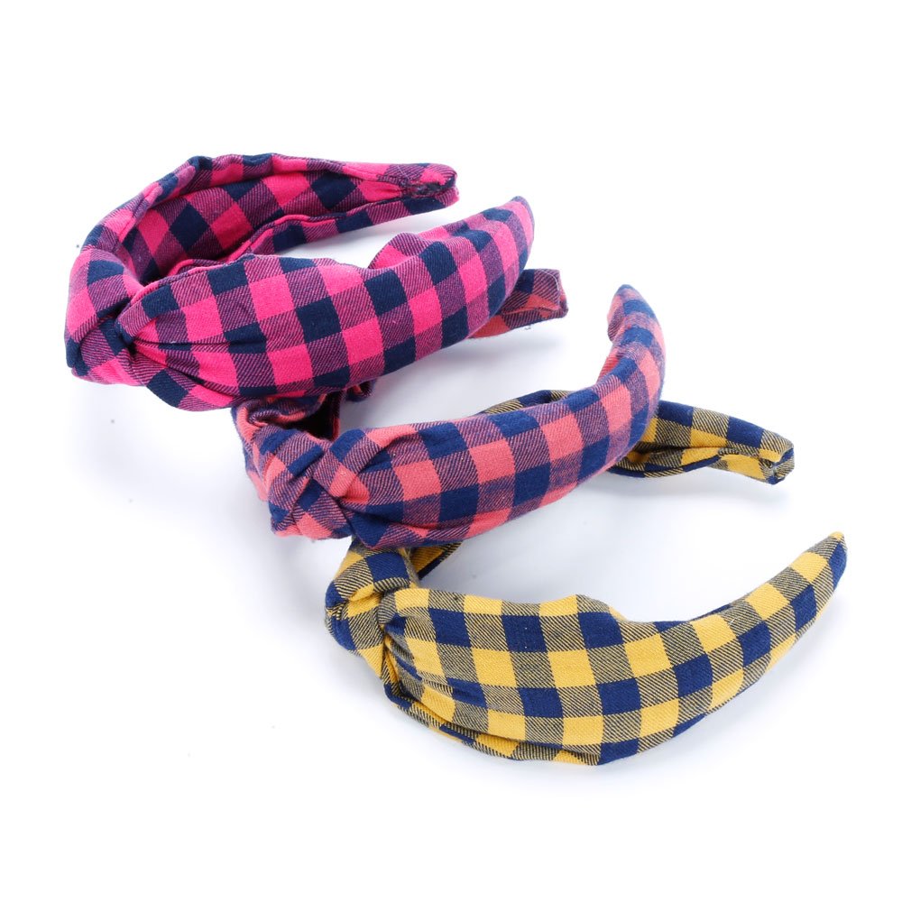 Three girls' padded plaid headbands in pink and navy, coral and navy, and mustard and navy