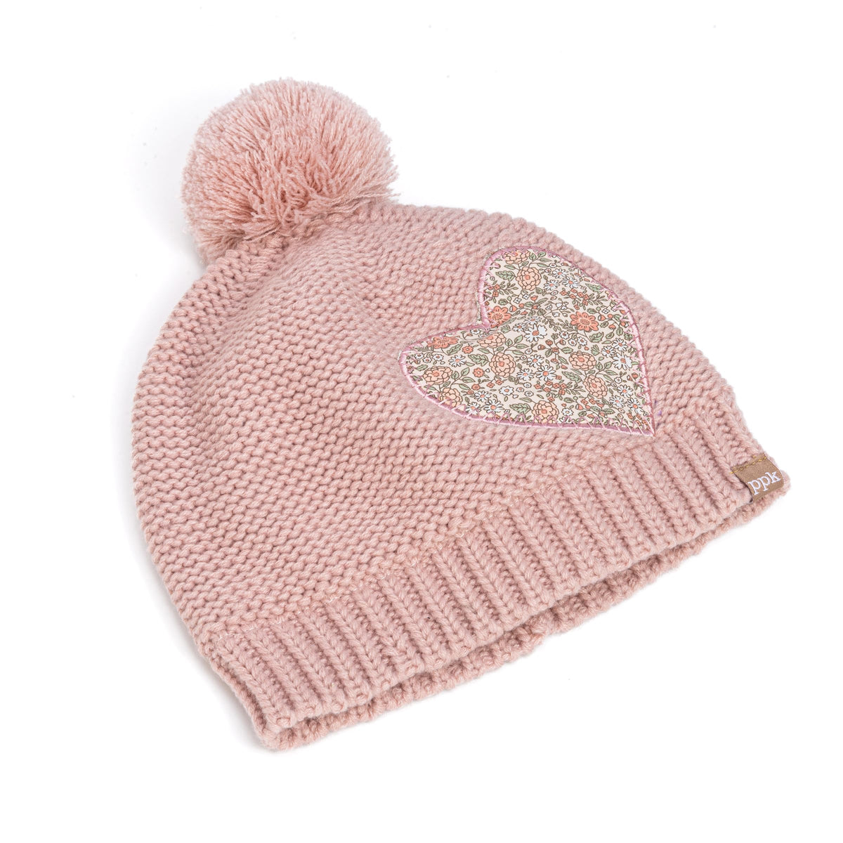 Pink knit beanie with ribbed brim, pom-pom, and floral heart patch