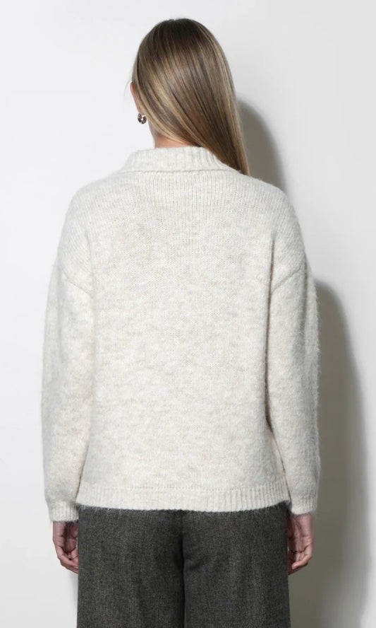 Cream knit cardigan back view with ribbed hem and long sleeves.