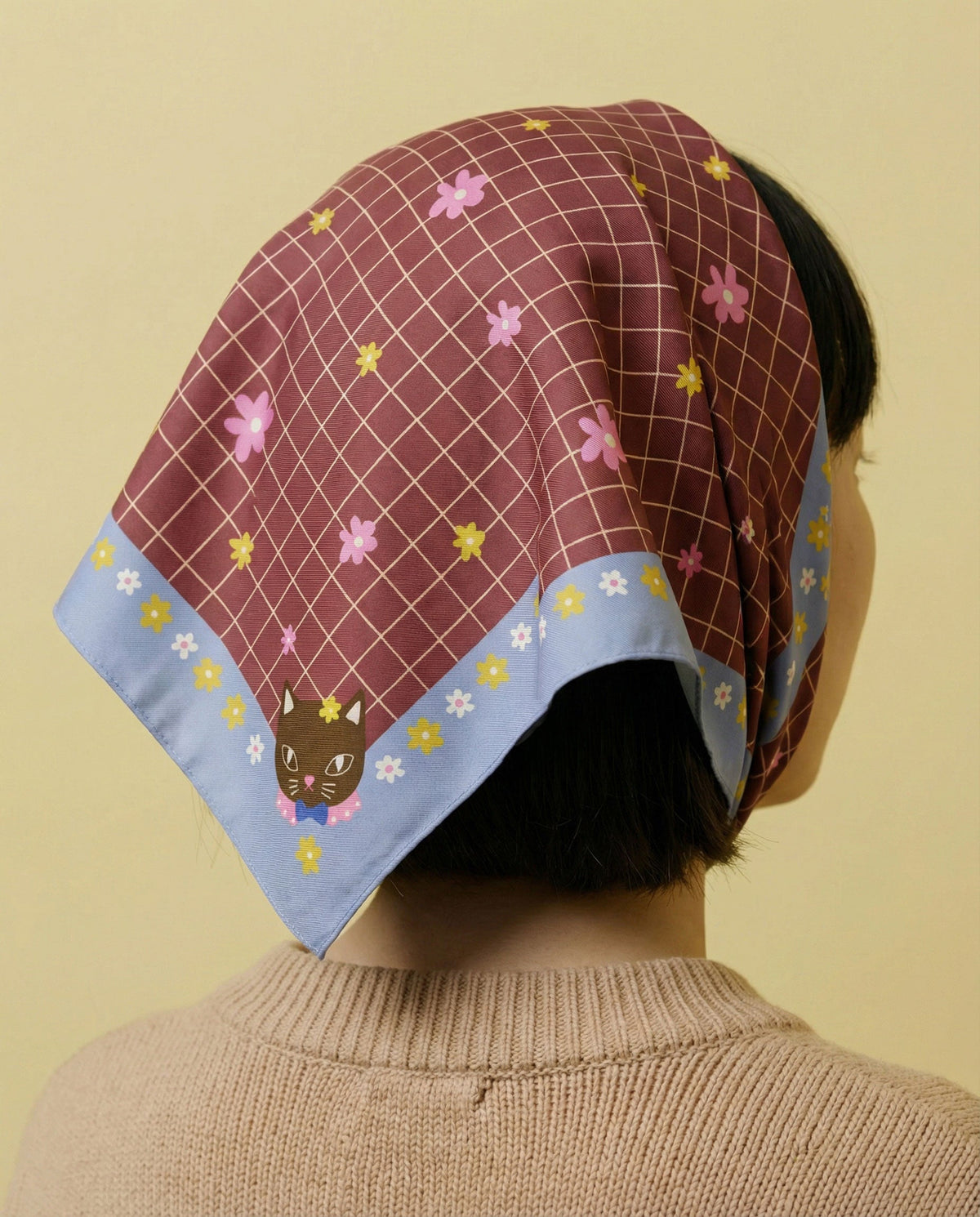 Cotton silk bandana worn on head; maroon grid with pink flowers and light blue border