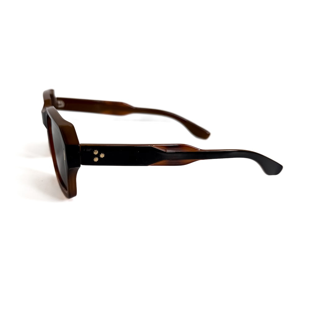 Side view of tortoise-and-black square sunglasses with dark lenses.