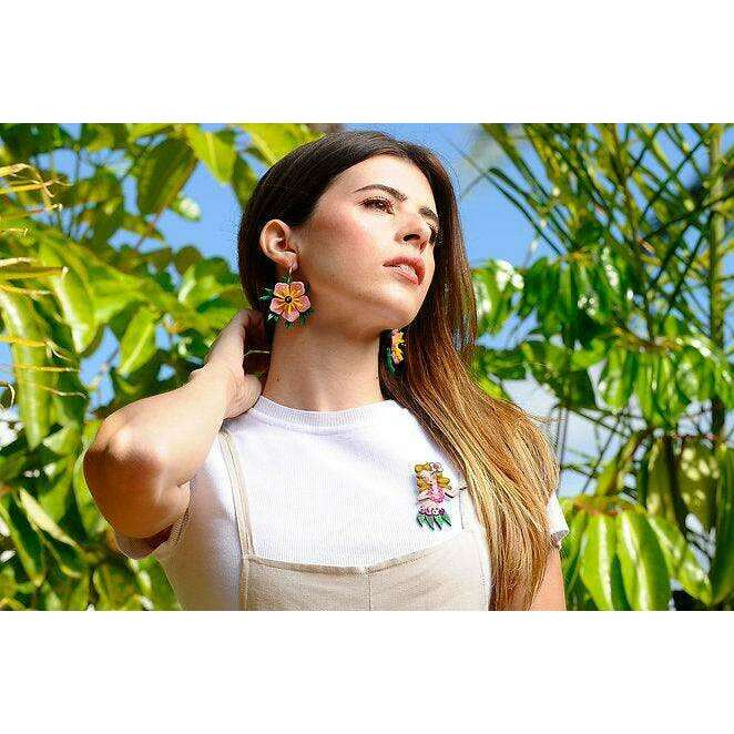 Laliblue hula girl brooch worn on cream top, with pink and yellow flower detail