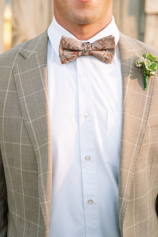 Men's pre-tied bow tie with floral pattern, worn with white shirt