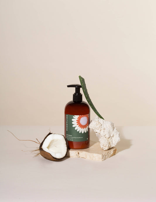 Dog conditioner bottle with black pump, amber liquid, with coconut and green leaf