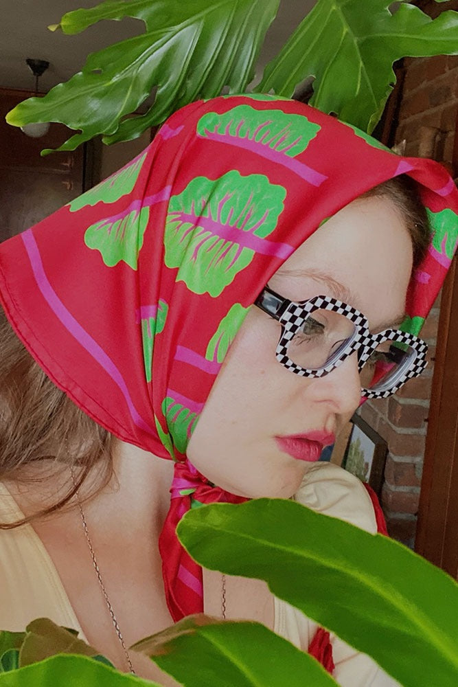 Silk square scarf worn headscarf style, magenta with bright green leaf print