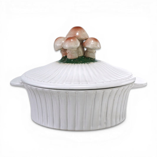 White ceramic fluted baking dish with mushroom-shaped lid and raised ridges