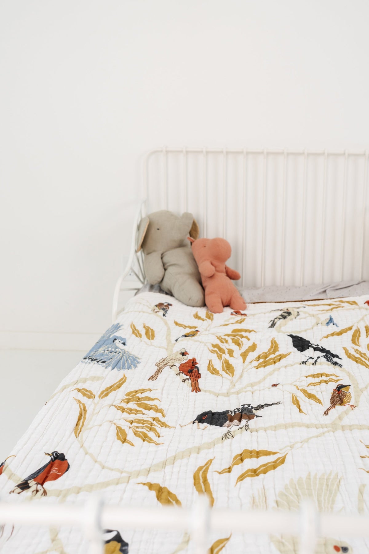 Bird and leaf throw blanket, cream background with blue and orange accents