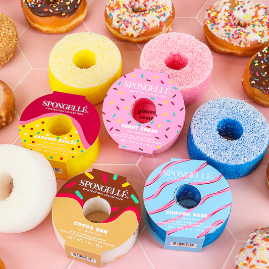 Donut-shaped bath buffers in yellow, pink, blue, and brown, with product boxes.