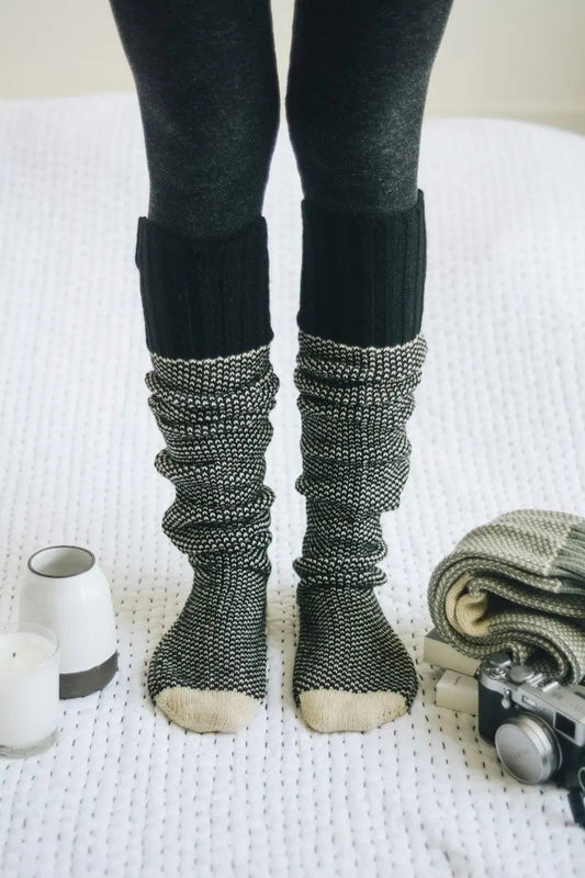 Ribbed knit lounge socks in dark charcoal with speckled gray cuffs and cream toes