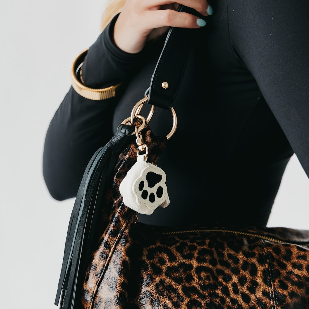 Skull pet bag charm with metal clip on a black bag strap