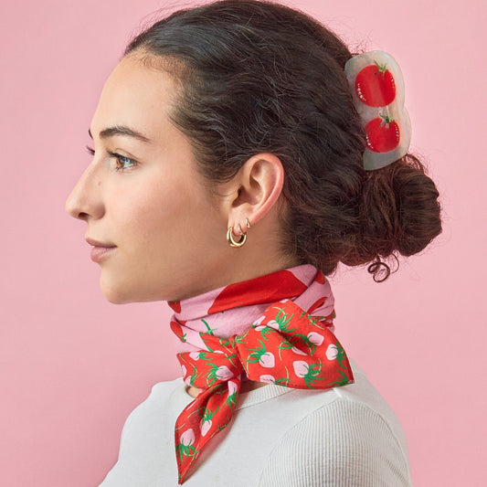 Tomato-print cotton silk bandana tied at neck, pink base with red tomatoes and green leaves