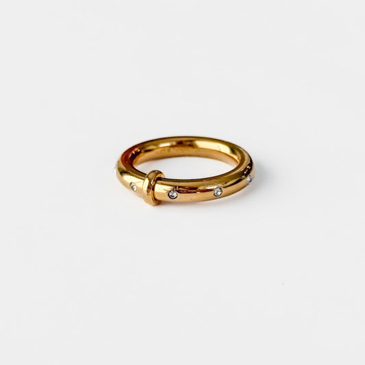Gold tone diamond-studded band ring with small round stones
