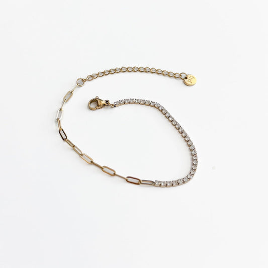 Gold-tone bracelet with tennis row of clear stones and heart-shaped charm clasp