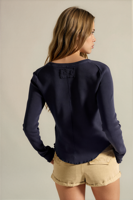 Dark long-sleeve tee back view with crew neck and small rectangular patch