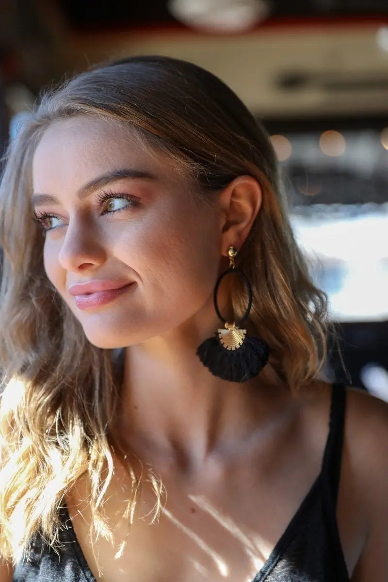 Tassel fan drop earrings on model, gold hoop with black fabric fan tassel