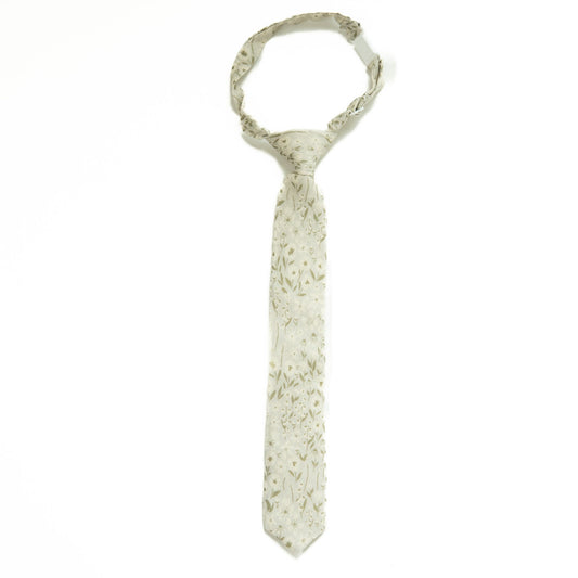 Boys tie in light fabric with small floral print, slim necktie design.