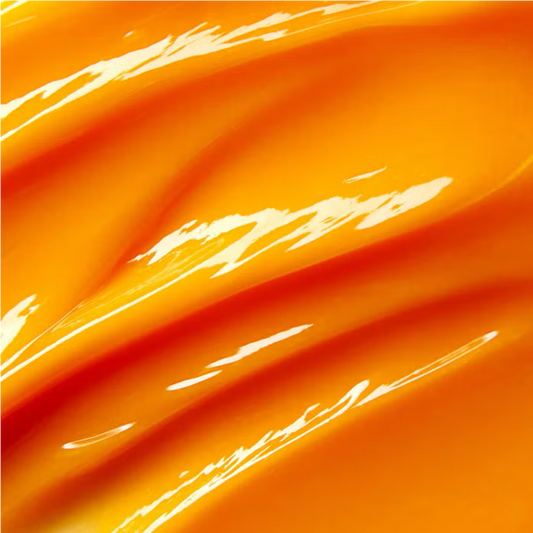 Orange cleansing butter swirl texture, glossy golden-yellow spread